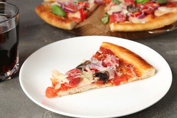 Slice of tasty pizza with thin smoked sausages served on grey table, closeup