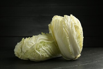 Fresh Chinese cabbages on black table, closeup