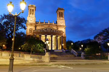 The view of the facade of the Saint Vincent de Paul church in Paris at night . It was built between...