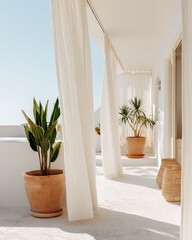 Bright, airy balcony with flowing curtains and lush green plants