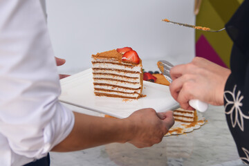 Slice of Classic Medovik Honey Layer Cake layers of honey sponge and creamy filling topped with...