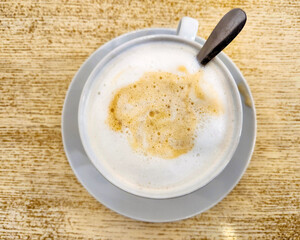 Coffee and foam close up. Coffee latte on wooden table. flatlay and copy space