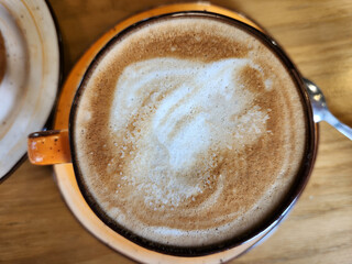 Top-down view of a cappuccino, flat lay and copy space.