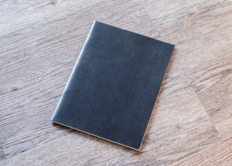 Book mockup blank black A4 leather cover for magazine, booklet, brochure, menu, diary mock-up design template on wooden table background