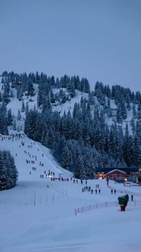 Spectators heading out into the night to see 39th Pierra Menta skimo race in Beaufort, France.