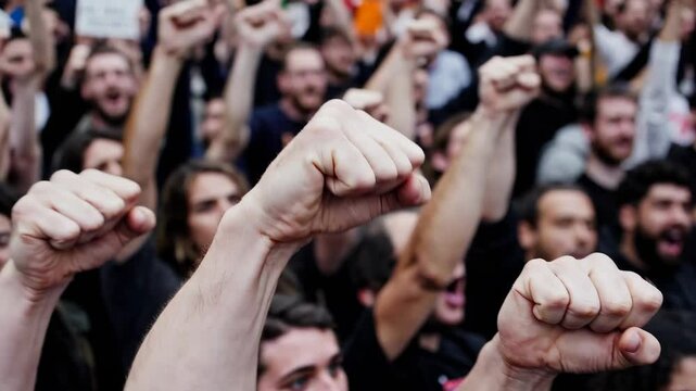 Energetic crowd raises fists in a powerful protest march for change, unity, and activism