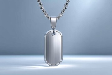 A single military dog tag hanging from a nail on a plain wall with light casting a soft shadow
