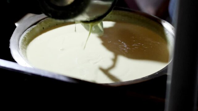 Close up sweet martabak dough in pan. The process of making  Martabak Manis, sweet pancake Indonesian Dessert (terang bulan).
