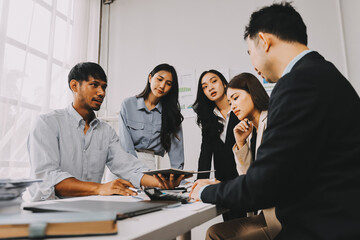 Team of financial advisory services. Asian advisor showing plan of investment to clients in the consultancy office..