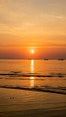 a beautiful orange sunset on the beach of Thailand. The sun sets in the sea in the tropics.