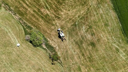 a tractor in the field shot with a drone	
