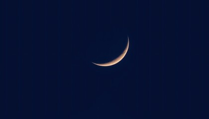 Crescent Moon's Delicate Curve Illuminating the Night Canvas of Deep Blue Skies
