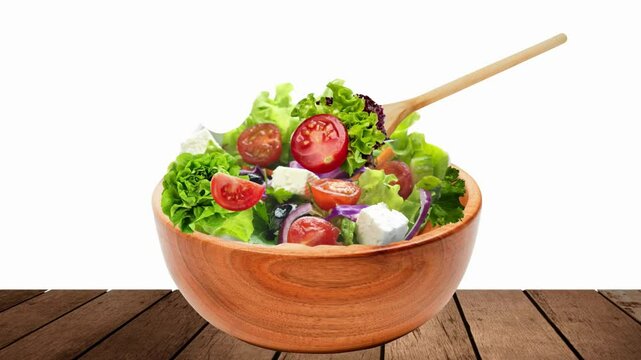 A video animation featuring a wooden salad bowl with a wooden spoon scooping up vegetables. Healthy food.