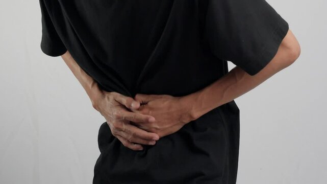 A man having abdominal pain. A man holding his stomach with his hands and feel pain. health and medical concept