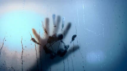 Frozen handprint on frosted window pane.