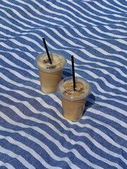 Two Iced Coffees on a Striped Blanket