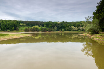 Fototapeta premium forest reflection on calm lake