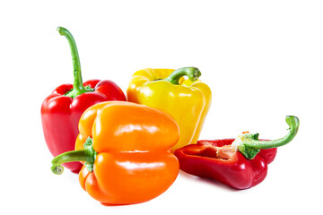 Mix of colorful whole and sliced ​​bell peppers. Isolated on white background.