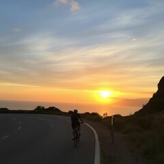 silhouette of a man riding a bike