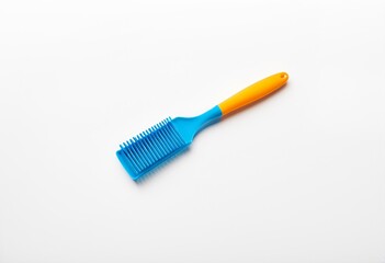 A blue and orange brush on a white surface.