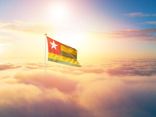 Togo flag waving light background hidden in the sky.