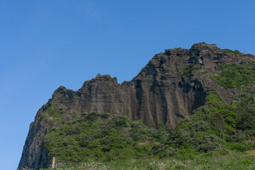 Seongsan Ilchulbong volcanic tuff cone, natural landscape, Jeju, South Korea, Umutgae Coast, clear blue sky