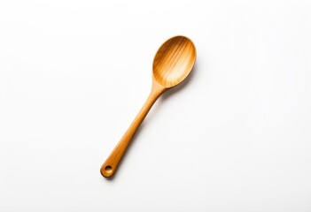 A wooden spoon on a white surface.