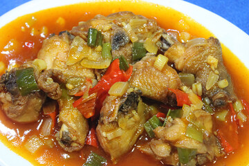 Close up photo of stir-fried chicken in sweet and sour sauce