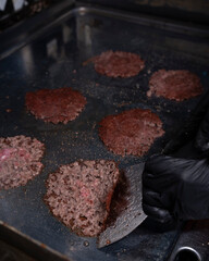 Smash burger patties sizzling on the griddle
