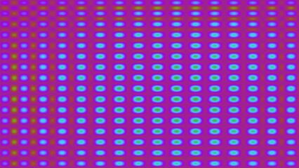 Vibrant, repeating pattern of blurred circles in purple and green hues