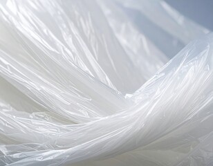 Obraz premium A crumpled white plastic bag partially filled with translucent, clear material, resting on a smooth surface, casting soft shadows around it.
