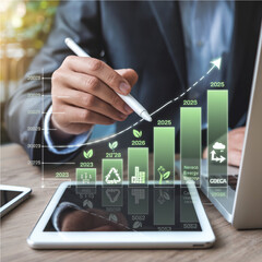 Businessman analyzing digital sustainability growth chart with future data trend
