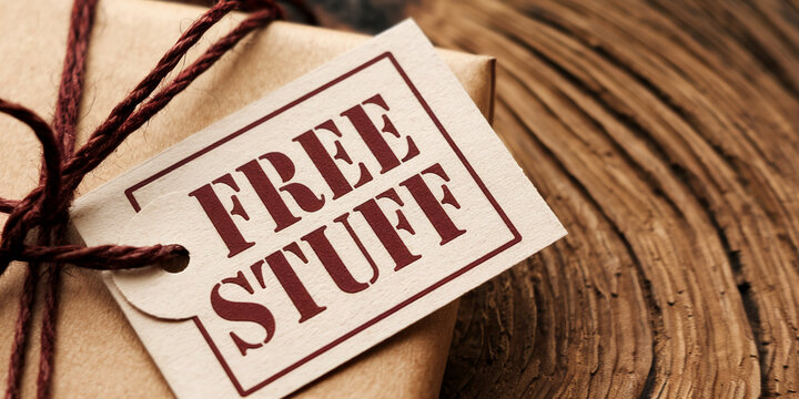 Close-up of a gift package with a tag reading "Free Stuff", tied with brown twine. Shows a freebie or giveaway concept, perfect for marketing or promotional material