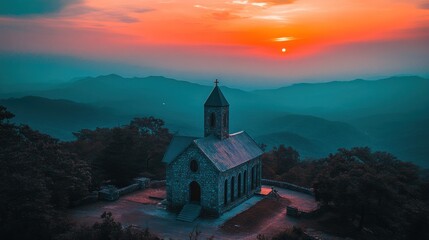 Fototapeta premium Serene Sunset at Mountaintop Chapel: A Breathtaking View