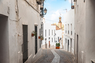 a cobbled street with typical white houses in Arcos de la Frontera, province of Cádiz, Andalusia, Spain