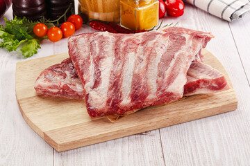 Raw pork ribs over board