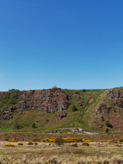 The view across the grasslands behind St Cyrus Beach to the Nether Kirkyard Burial ground at the foot of the Volcanic Cliffs.