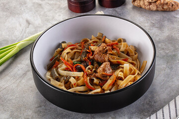 Asian cuisine udon with chicken and vegetables