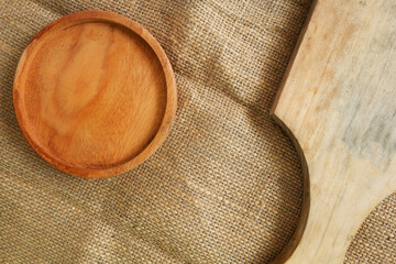 wooden plate and wooden cutting board on a burlap cloth for display product