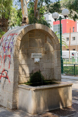 The Radon water stream flows gently through Loutraki, surrounded by greenery and rocks. A small...