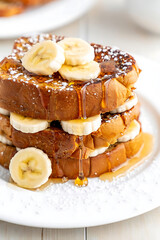 Delicious Stack of French Toast with Bananas, Whipped Cream, and Honey Drizzle