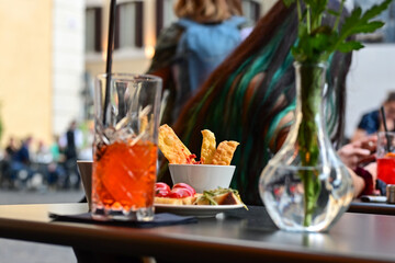  Aperol Spritz  and tipical italian snack for aperitivo in a bar in Rome, Italy
