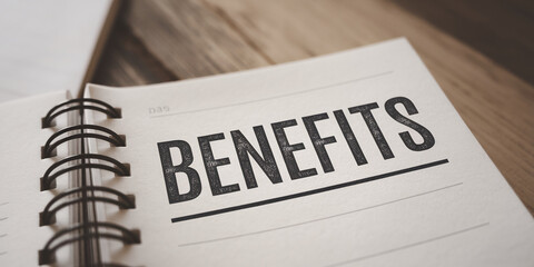 Close-up of notebook page showing the word BENEFITS, printed in bold, black type, representing business advantages, planning, or financial gains