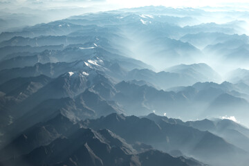 View of the mountains from the window of a flying airplane