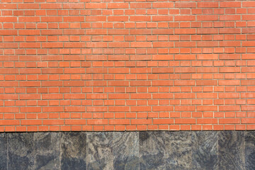 A wall of red bricks. The wall is smooth and neat.