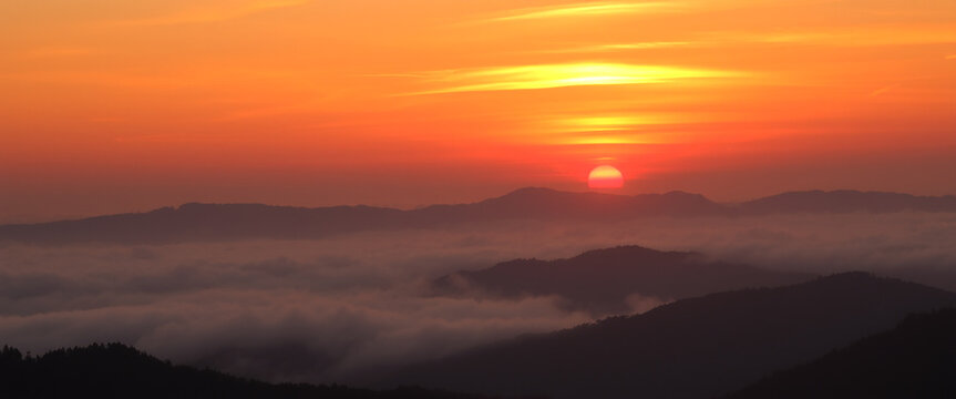 Breathtaking sunrise over mountain range and misty valley creating a beautiful landscape - Powered by Adobe