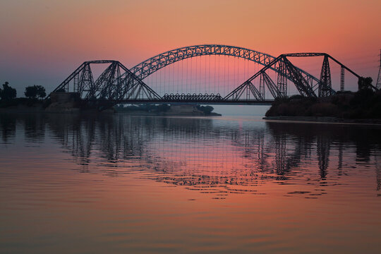 Sun setting down on the Lansdowne Bridge at the Indus River, Sukkur, Sindh, Pakistan