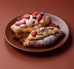 Food for breakfast sweet strawberry croissants with chocolate filling