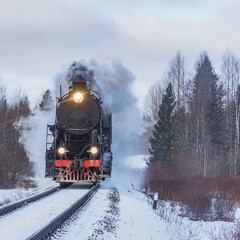 Retro steam train arrives at winter.