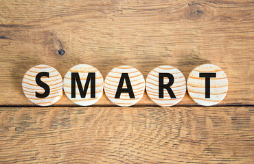 Smart symbol. Concept word Smart on beautiful wooden circles. Beautiful wooden table wooden...